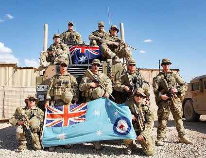 Members of the RAAF pose with the RAAF Ensign whilst serving in Afghanistan