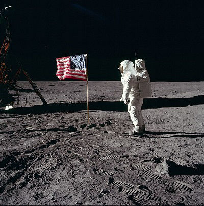 Astronaut Buzz Aldrin alongside the USA flag during the moon landing of 1969