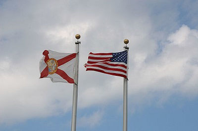 A Florida flag flies next to a United States of America flag