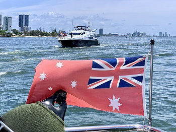The Australian Red Ensign attached to a vessel on the water in Queensland, Australia