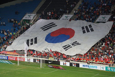 A large South Korean flag on display at a football match