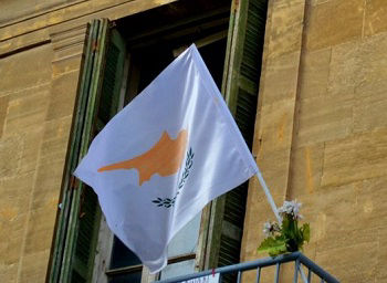The flag of Cyprus flies outside a building
