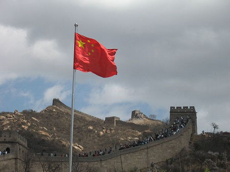 The flag of China flies over the Great Wall of China