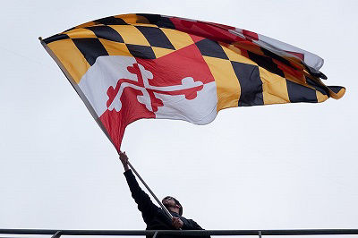 A large Maryland flag flies at a Baltimore Ravens game