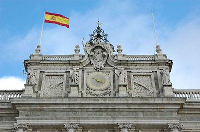 The flag of Spain flies outside the Royal Palace of Madrid