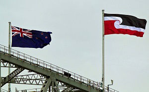 The Maori flag (right) flies alongside the New Zealand flag on the Auckland Harbour Bridge in Auckland, New Zealand on Waitangi Day