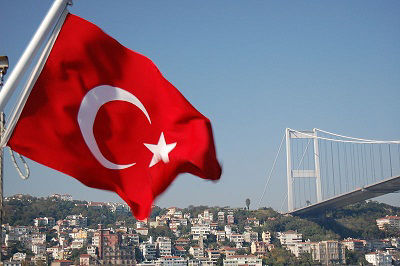 The flag of Turkey flying close to the Bosphorus Bridge