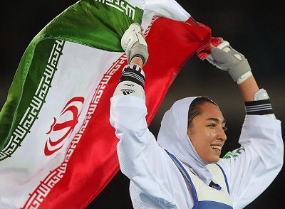 Iranian athlete Kimia Alizade performs a lap of honour with the flag of Iran during the 2016 Summer Olympic games in Brazil
